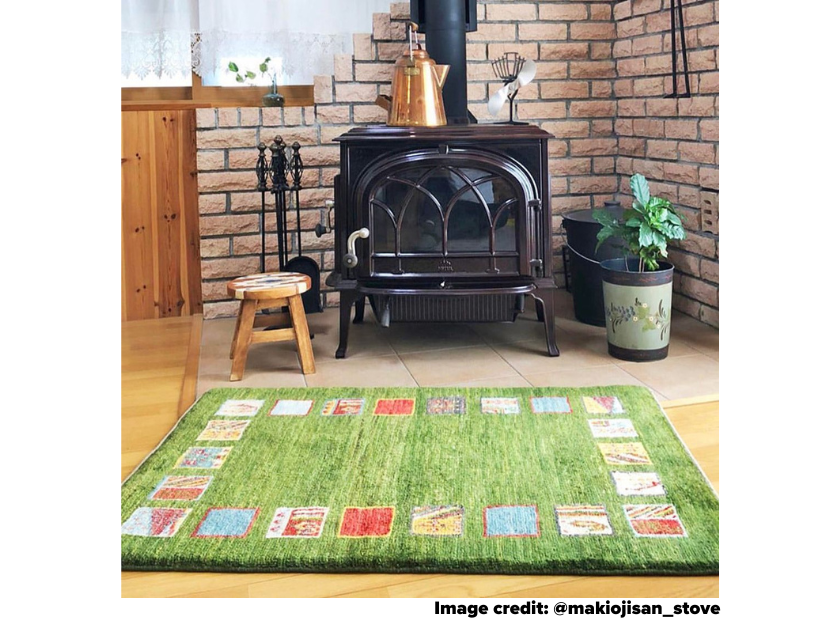 Wood stove in summer with flowers and Ecofan